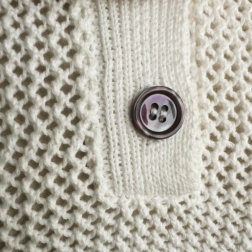 Cream button knit pocket detail